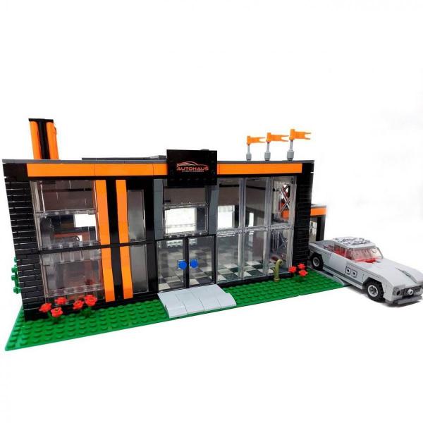 Autohaus und Werkstatt mit Auto